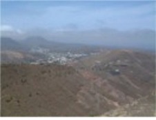 Click for larger picture What goes up must go down.......down to Haria via steep, blind, switchbacks (rocky outcrops stop you from seeing round them) and the wind blasts from the left or is it the right or front or...........